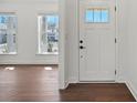Bright entryway featuring wood floors, white trim, and a door with glass panel allowing for natural light to fill the foyer at 2176 Millennium Dr # 093, Lancaster, SC 29720