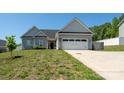 Inviting home featuring a two-car garage, vinyl siding, and a well-manicured front yard at 2205 Philadelphia Church Rd, Dallas, NC 28034