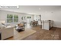 Bright living space with hardwood floors, an adjacent dining area and kitchen featuring an open concept layout at 2917 Penninger Cir, Charlotte, NC 28262