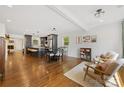 Open-concept living space featuring hardwood floors, modern furniture, and a view into the adjacent kitchen at 2933 Hilliard Dr, Charlotte, NC 28205