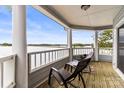 Covered porch featuring lovely lake views and comfy outdoor seating at 372 Northwest Dr, Davidson, NC 28036