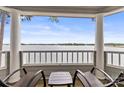 Relaxing screened porch featuring serene lake views and comfortable seating at 372 Northwest Dr, Davidson, NC 28036
