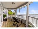 Enjoy stunning lake views from this spacious porch with rocking chairs at 372 Northwest Dr, Davidson, NC 28036