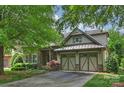 Charming home with a two-car garage, stone accents, mature trees and landscaping at 4122 Banfield Pl, Charlotte, NC 28226
