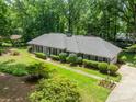 Aerial view of the home showing the lush lawn and landscaping, driveway, and mature trees at 532 Courtney Ln, Matthews, NC 28105