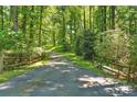 A tree-lined driveway leads to the property, providing privacy and curb appeal at 6108 Phyliss Ln, Mint Hill, NC 28227