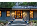 Inviting front entrance featuring a decorative stairway, glass front door and exterior lighting at 6108 Phyliss Ln, Mint Hill, NC 28227