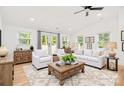 Spacious living room with a beamed ceiling, hardwood floors, and comfortable seating arrangement at 6301 Vernedale Rd, Charlotte, NC 28212