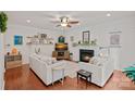 Cozy living room with a fireplace, hardwood floors, and stylish furnishings, perfect for relaxing at 7049 Sedgebrook W Dr, Stanley, NC 28164