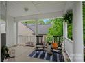 Inviting front porch with rocking chairs and stylish decor, perfect for relaxing outdoors at 7049 Sedgebrook W Dr, Stanley, NC 28164