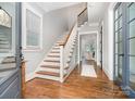 Inviting foyer with hardwood floors, staircase, and natural light from a large window at 710 Morgan Park Dr, Charlotte, NC 28204