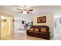 Comfortable living room with brown leather sofa and doorway views to kitchen and a bright bathroom at 712 Grace Ave, Kannapolis, NC 28083