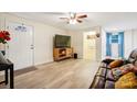 Cozy living room with a ceiling fan, a television, and a comfortable brown leather couch with colorful pillows at 712 Grace Ave, Kannapolis, NC 28083