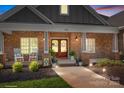 Inviting covered front porch with rocking chairs, decorative plants, and double doors at 730 Oak Ridge Farms Cir # 14, Newton, NC 28658