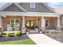 Inviting front porch featuring rocking chairs, a brick facade, and decorative planters creating a cozy entrance at 730 Oak Ridge Farms Cir # 14, Newton, NC 28658