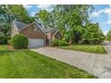 Charming brick home with a well-manicured lawn, mature trees, and a two-car attached garage at 752 Pinebough Ln, Rock Hill, SC 29732