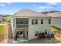 Two-story home with a screened porch and outdoor seating, plus a fenced yard surrounded by mature trees at 7620 Porrera St, Charlotte, NC 28214
