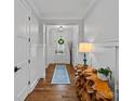 Bright foyer with hardwood floors, white trim, and stylish wooden table at 7730 Burning Ridge Dr, Stanley, NC 28164