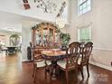 Dining room features a decorative chandelier and a china cabinet with dining table at 7923 Shiny Meadow Ln, Charlotte, NC 28215