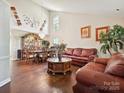 Spacious living area with high ceilings, hardwood floors, and elegant furnishings at 7923 Shiny Meadow Ln, Charlotte, NC 28215
