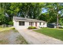 Beautifully landscaped single-story home with a white facade and a long, paved driveway at 808 Sharon Dr, Waxhaw, NC 28173