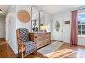 The foyer has hardwood floors, a decorative chair and table, with 2 large mirrors above the table at 808 Sharon Dr, Waxhaw, NC 28173