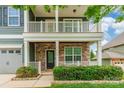 Inviting two-story home featuring a welcoming front porch with decorative stone accents and manicured bushes at 9109 Loch Glen Way, Charlotte, NC 28278