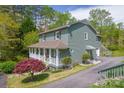 This lovely home features a cozy front porch, a side deck, and a well-maintained driveway at 1009 Catawba Valley Se Blvd, Hickory, NC 28602