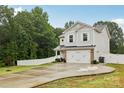 Beautiful two-story home featuring a long driveway and well-manicured lawn at 104 Trellis Ln, Troutman, NC 28166