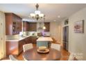 Bright kitchen with an island, stainless steel appliances, stylish lighting, and adjacent dining area at 10501 Stonemede Ln, Matthews, NC 28105