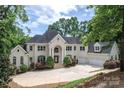Beautiful home with manicured landscaping, a circular driveway, and a grand entrance framed by elegant columns at 110 Cramer Mountain Woods None, Cramerton, NC 28032
