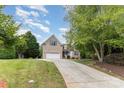 Charming brick and siding home with a long driveway and lush green lawn at 14807 Middlesborough Dr, Matthews, NC 28104