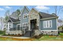 Beautiful exterior featuring stone accents, a covered porch, and a lovely landscaped yard at 149 Shady Cove Rd, Troutman, NC 28166