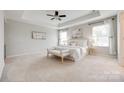 Spacious main bedroom boasting a tray ceiling, neutral tones, and plush carpeting at 1507 Arcadia Bluff Dr, York, SC 29745