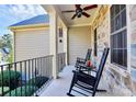 Comfortable front porch featuring rocking chairs, ceiling fans, and stone accents at 162 Kenway Loop, Mooresville, NC 28117