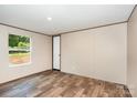 A cozy bedroom offers natural light and a neutral color palette at 1785 Doe Ct, Iron Station, NC 28080