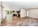 Bright living room flows into kitchen with modern appliances and sliding doors at 1785 Doe Ct, Iron Station, NC 28080