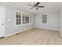 Bright living room with large windows, wood-look floors, neutral paint and a ceiling fan at 1874 Sunny Ln, Lancaster, SC 29720