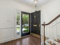 Inviting foyer featuring hardwood floors, a stylish front door, and staircase at 232 Perrin Pl, Charlotte, NC 28207