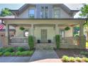 Inviting front porch with stone accents and hanging plants, perfect for relaxing at 3009 Thayer Dr, Waxhaw, NC 28173