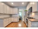 Bright kitchen featuring white cabinets, granite countertops, and stainless steel appliances at 3009 Thayer Dr, Waxhaw, NC 28173