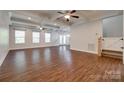 Spacious living room with coffered ceilings, ceiling fans, and hardwood floors at 3243 Farmcrest Ct, Fort Mill, SC 29708