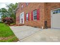 Close-up of a brick home's facade, including the front door, garage entry, and landscaping at 3602 Brookstone Trl, Indian Trail, NC 28079
