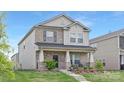 Charming two-story home with a brick facade, landscaped front yard, and covered porch at 363 Cedar Knoll Cir, Pineville, NC 28134