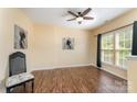 Spacious living room with hardwood floors, a ceiling fan, and natural light at 4208 Carl Parmer Dr, Harrisburg, NC 28075