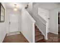 Bright entryway featuring wood floors, staircase, and a white front door at 507 Newfound Hollow Dr, Charlotte, NC 28214