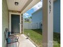 Inviting front porch with seating area and view of the landscaped yard at 507 Newfound Hollow Dr, Charlotte, NC 28214