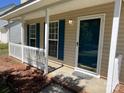 Inviting front porch showcasing white railings and blue shutters for a cozy welcome at 5637 Hedgecrest Pl, Charlotte, NC 28269