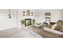 Bright living room showcasing a fireplace, wood flooring, and neutral color palette at 6012 Tuckaseegee Rd, Charlotte, NC 28208