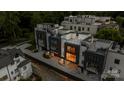 Wide aerial of modern townhouses with rooftop decks, dark garage doors, and balconies against lush greenery at 614 Queens Rd, Charlotte, NC 28207